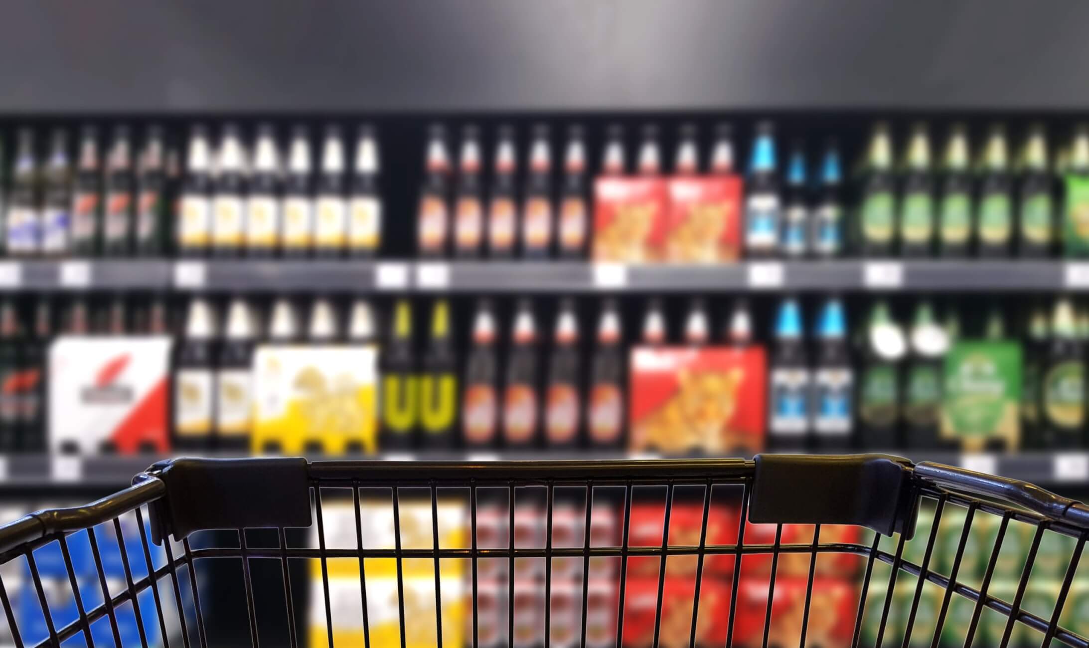 Abstract blurred image of alcohol store with trolley (Selective
